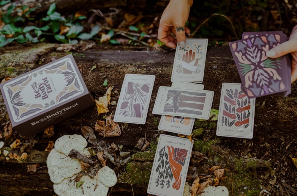 Cards laid out mid-reading on a log in the woods